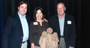 From left, Dax Brott poses with parents Bernadette and Garth behind BMI Mechanical's California Family Business Award. 