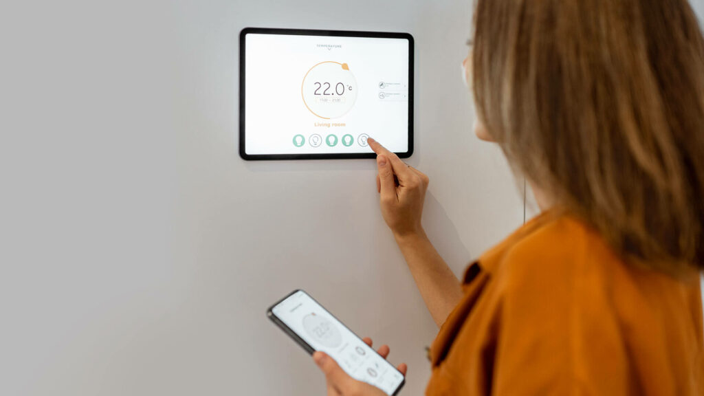 woman controlling heating with a smart devices
